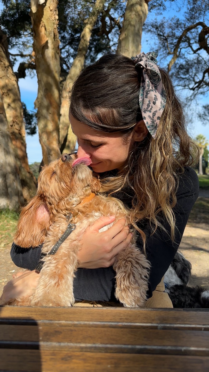 Mireya Gonzalez cuddling a happy pup